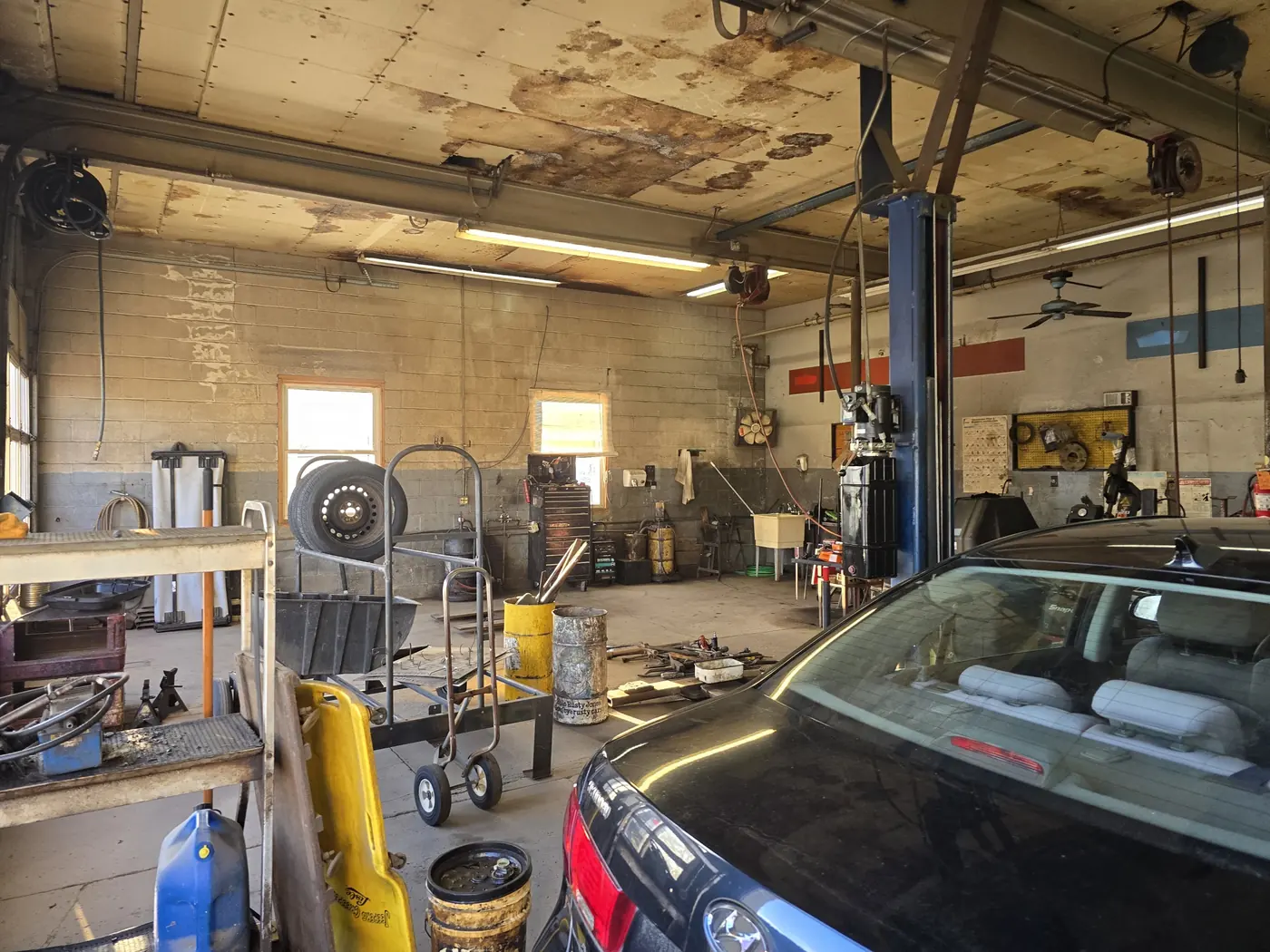 The workshop floor at Cutts and Bruises, with a vehicle in the bay and tools at hand